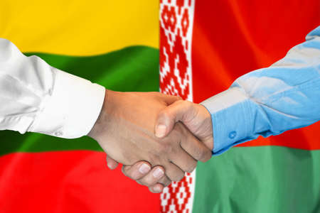 Business handshake on the background of two flags. Men handshake on the background of the Lithuania and Belarus flag. Support conceptの写真素材
