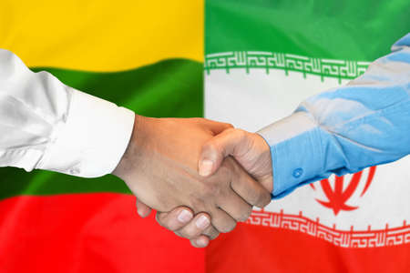 Business handshake on the background of two flags. Men handshake on the background of the Lithuania and Iran flag. Support conceptの写真素材