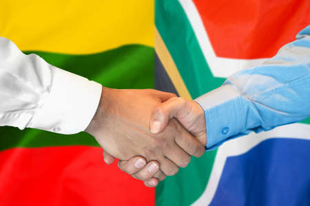 Business handshake on the background of two flags. Men handshake on the background of the Lithuania and South Africa flag. Support conceptの写真素材