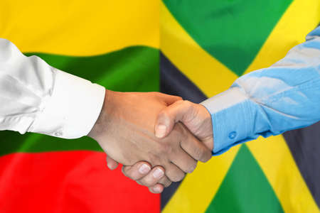 Business handshake on the background of two flags. Men handshake on the background of the Lithuania and Jamaica flag. Support conceptの写真素材