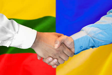 Business handshake on the background of two flags. Men handshake on the background of the Lithuania and Ukraine flag. Support conceptの写真素材