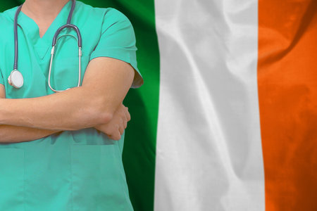 Male surgeon or doctor with stethoscope on the background Ireland flag. Health care and medical concept. Surgery concept in Irelandの写真素材