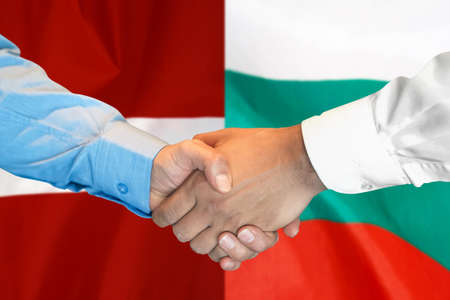 Business handshake on background of two flags. Men handshake on background of Bulgaria and Latvia flag. Support conceptの写真素材