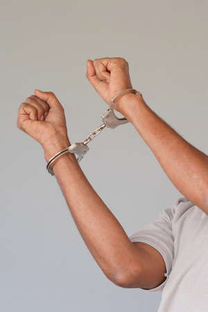 African american man handcuffs. Criminal african hands locked in handcuffsの写真素材