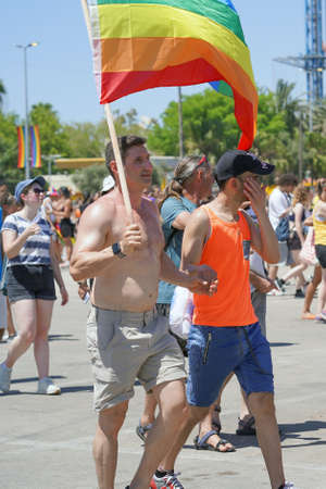 Portrait of two mans with rainbow flag in the Gay Pride parade. The annual LGBT parade. parade of tolerance. Rainbow flags at gay pride parade. 10 June 2022. Tel Aviv. Israelのeditorial素材