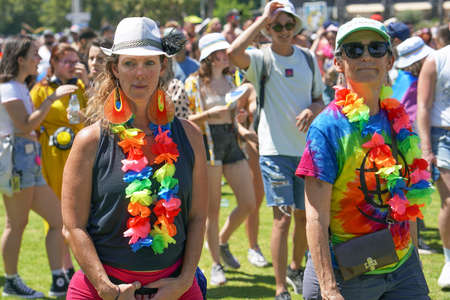 Portrait of two elderly lesbians at parade of tolerance against the backdrop of a crowd of people.. The annual LGBT parade. Rainbow flags at gay pride parade. 10 June 2022. Tel Aviv. Israelのeditorial素材