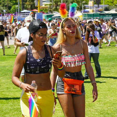 Two cheerful lesbians in the Gay Pride parade. The annual LGBT parade. parade of tolerance. Rainbow...