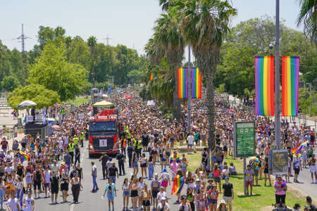 An aerial view of a crowd of people wearing rainbow flags at the Tolerance. Parade in Tel Aviv. The...