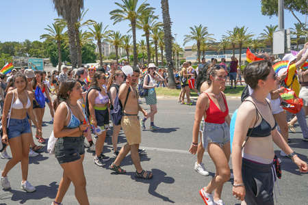View of a crowd of people wearing rainbow flags at the Tolerance. Young girls and boys with rainbow flags Parade in Tel Aviv. The annual LGBT parade. 10 June 2022. Tel Aviv. Israelのeditorial素材