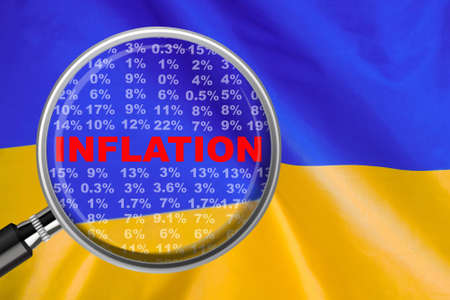 Magnifying glass focused on the word inflation on Ukraine flag background. Hike interest rate. inflation income crisis. Inflation, tax, cash flow and another financial concept in Ukraineの写真素材