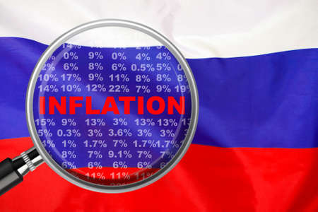Magnifying glass focused on the word inflation on Russia flag background. Hike interest rate. inflation income crisis. Inflation, tax, cash flow and another financial concept in Russiaの写真素材