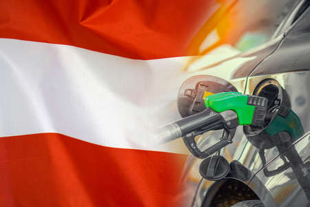 Car with a fuel injector on Austria flag background. Record fuel prices for population. Gasoline price increase during energy and fuel world crisis in Austriaの写真素材