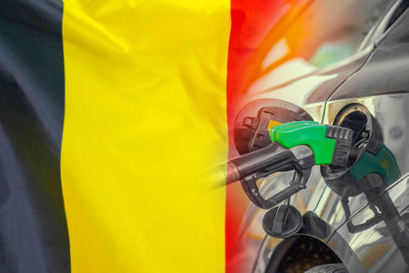 Car with a fuel injector on Belgium flag background. Record fuel prices for population. Gasoline price increase during energy and fuel world crisis in Belgiumの写真素材