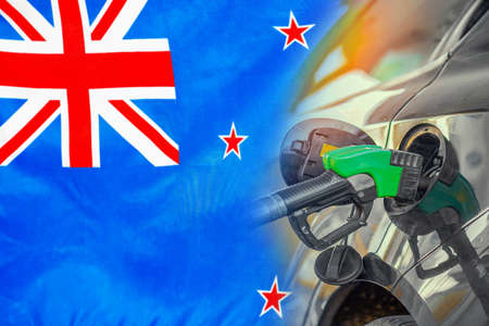 Car with a fuel injector on New Zealand flag background. Record fuel prices for population. Gasoline price increase during energy and fuel world crisis in New Zealandの写真素材
