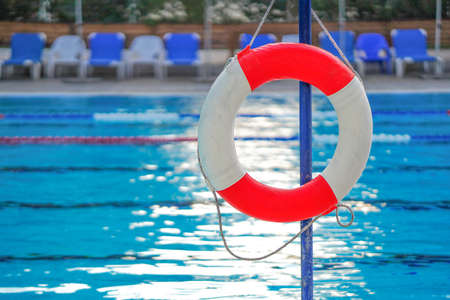 Life ring on swimming pool background. Life ring in swimming pool