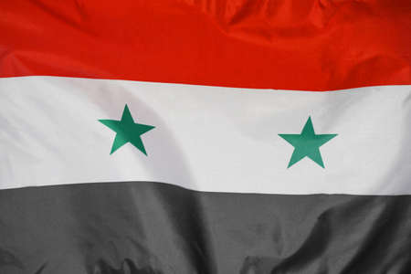 Fabric texture flag of Syria. Flag of Syria waving in the wind. Syria flag is depicted on a sports cloth fabric with many folds. sport team bannerの写真素材