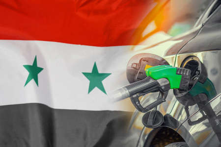 Car with a fuel injector on Syria flag background. Record fuel prices for population. Gasoline price increase during energy and fuel world crisis in Syriaの写真素材