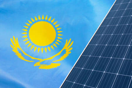 Solar panels against flag Kazakhstan background. Solar battery generates a pure electricity. Concept of sustainable resources and renewable energy in Kazakhstanの写真素材