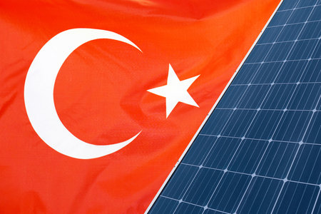 Solar panels against flag Turkey background. Solar battery generates a pure electricity. Concept of sustainable resources and renewable energy in Turkeyの写真素材