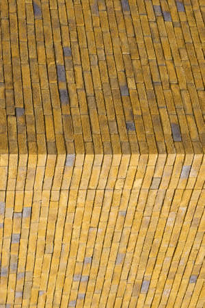 Yellow brick texture of the corner of the house. yellow brick wall for background or texture