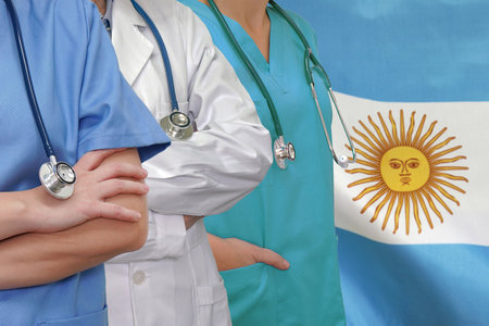 Three Doctors with stethoscope in standing on Indonesia flag background. Close-up medical team. Group of doctors. Innovative technologies in science and medicine, medical developmeの写真素材