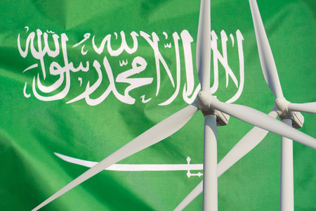 Two Wind Turbines for alternative energy on Saudi Arabia flag background. wind turbines generating electricity. Eco power and wind stations for renewable electric energy production in Saudi Arabiaの写真素材