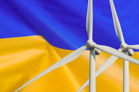 Two Wind Turbines for alternative energy on Ukraine flag background. wind turbines generating electricity. Eco power and wind stations for renewable electric energy production in Ukraineの写真素材