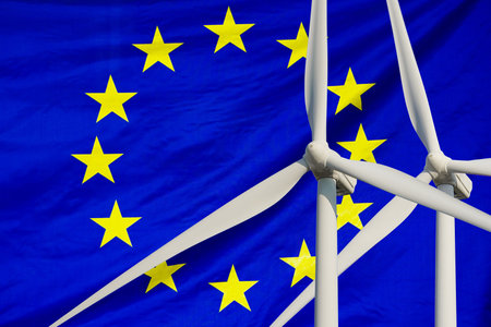 Two Wind Turbines for alternative energy on EU flag background. wind turbines generating...