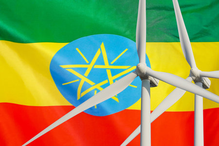 Two Wind Turbines for alternative energy on Ethiopia flag background. wind turbines generating electricity. Eco power and wind stations for renewable electric energy production in Ethiopiaの写真素材