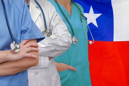 Three Doctors with stethoscope in standing on Chile flag background. Close-up medical team. Group of doctors and nurses. Innovative technologies in science and medicine, medical development in Chileの写真素材