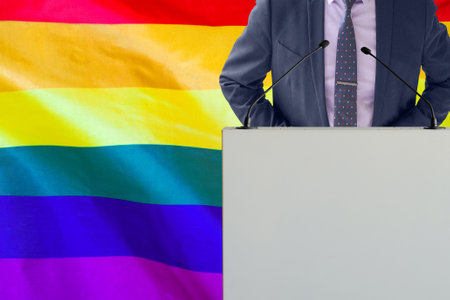 Tribune with microphone and man in suit on Ukraine flag background. Businessman and tribune on Ukraine flag background. Politician at the podium with microphones background Ukraine flagの写真素材