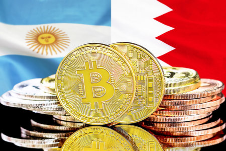 Bitcoins on flag Bahrain and Argentina background. Concept for investors in cryptocurrency and Blockchain technology in Bahrain and Argentinaの写真素材