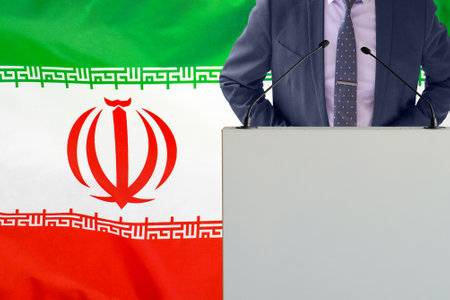 Tribune with microphone and man in suit on Iran flag background. Businessman and tribune on Iran flag background. Politician at the podium with microphones background Iran flag. business conferenceの写真素材