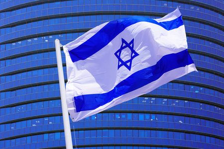Waving in the wind flag Israel on the background of a modern building. Concept of politics, business and tourism in Israelの写真素材