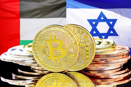 Bitcoins on flag of United Arab Emirates and Israel flag background. Concept for investors in cryptocurrency and Blockchain technology in UAE and Israelの写真素材