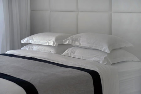 Empty bed in a hotel bedroom with soft cushions. tourism and vacation conceptの写真素材