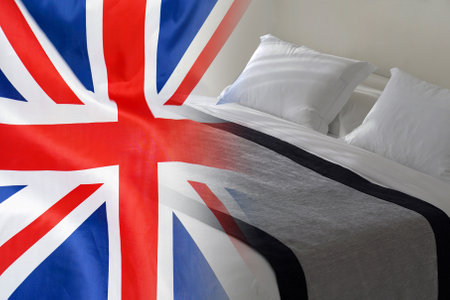 Hotel bed on the background of the UK flag. Tourism and hotel business in the United Kingdomの写真素材