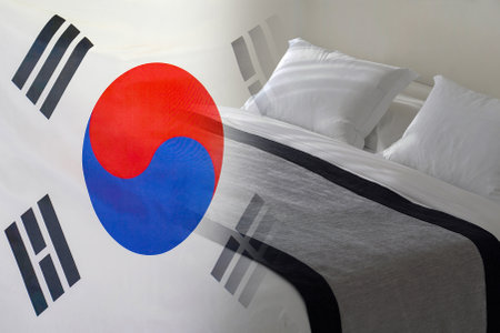 Hotel bed on the background of the South Korea flag. Tourism and hotel business in South Koreaの写真素材