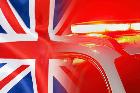Close-up of the red lights on top of UK police vehicle on flag of UK background. The concept of...