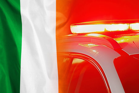 Close-up of the red lights on top of Ireland police vehicle on flag of Ireland background. The concept of crime and law in the Irelandの写真素材