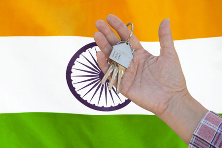 Hand shows the keys to the apartment on background of flag India. Keys to the apartment in a female...