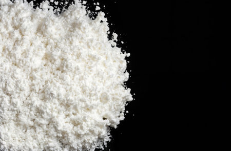 Synthetic drugs mephedrone concept. Narcotic and psychotropic drugs concept. White crystal powder on black backgroundの素材