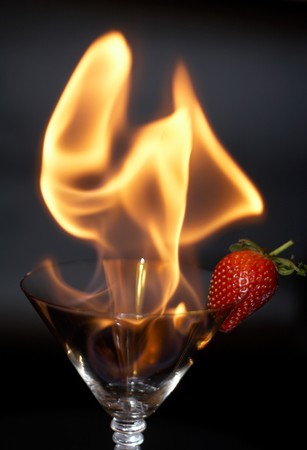 Strawberry and fire in a glassの写真素材