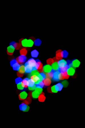 Heart-shaped lights pentagonal shape on a black background .