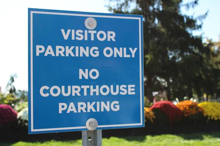 Parking sign on the road background.Warm autumn on the street.の写真素材