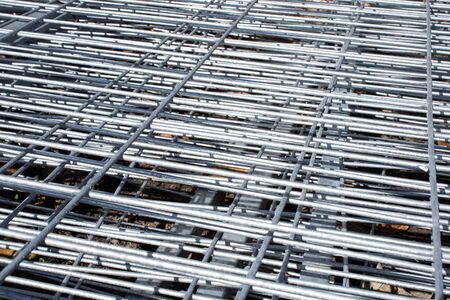 Metal grid industrial background in perspective.Construction art and texture.Metal material.Urban style concept.Outdoor renovation.Building the wall.の写真素材