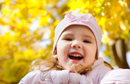 Autumn portrait of cute little caucasian girl の写真素材