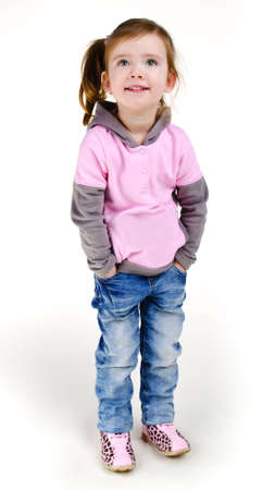 Portrait of happy smiling little girl in jeans isolatedの写真素材
