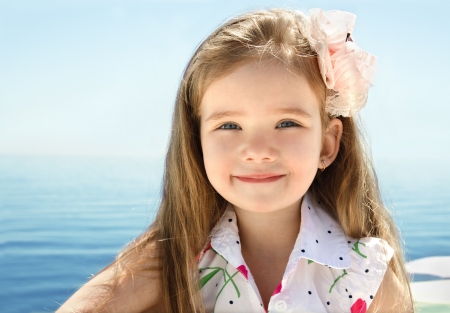 Adorable smiling little girl on beach vacationの写真素材