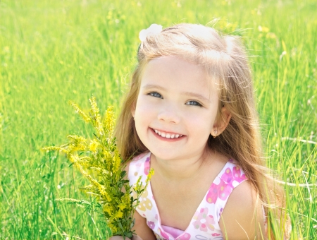 Cute little girl on the meadow with flowers in summer day Cute little girl on the meadow with flowers in summer day